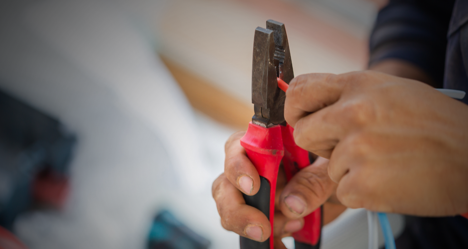 Anchor Electric specialist performing residential electrical rewiring and wire stripping services in Sarasota, Florida