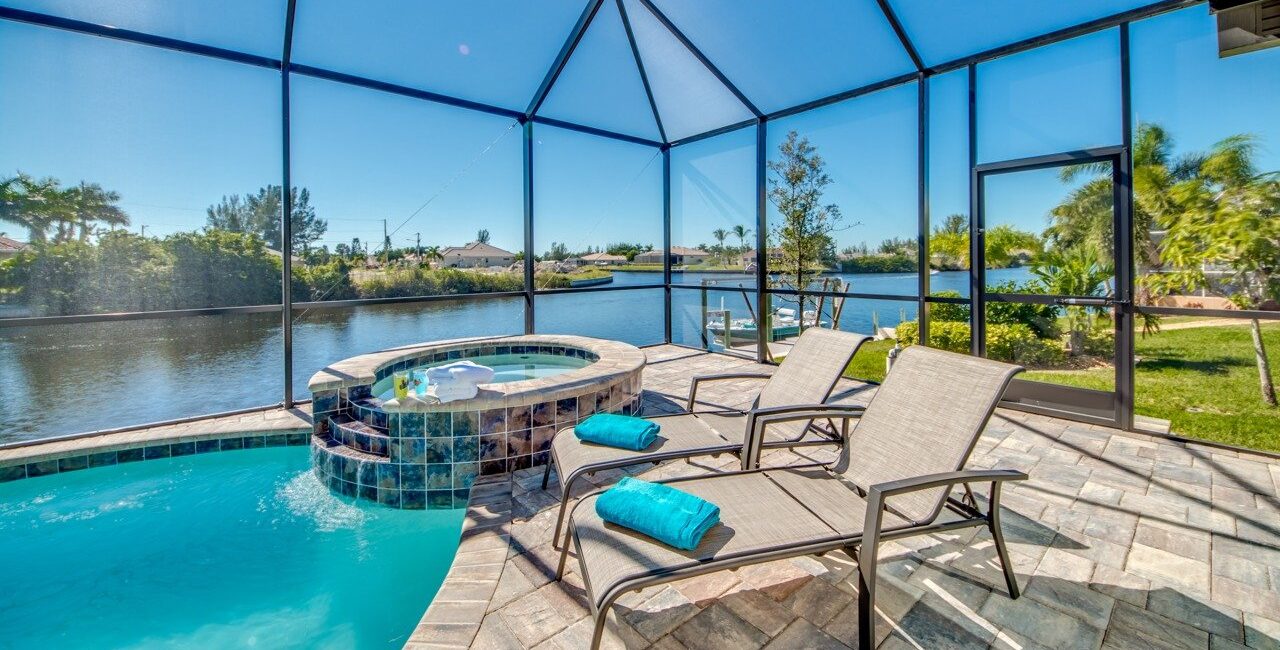 Anchor Electric professional outdoor lighting installation on a screened pool patio overlooking a Sarasota canal.