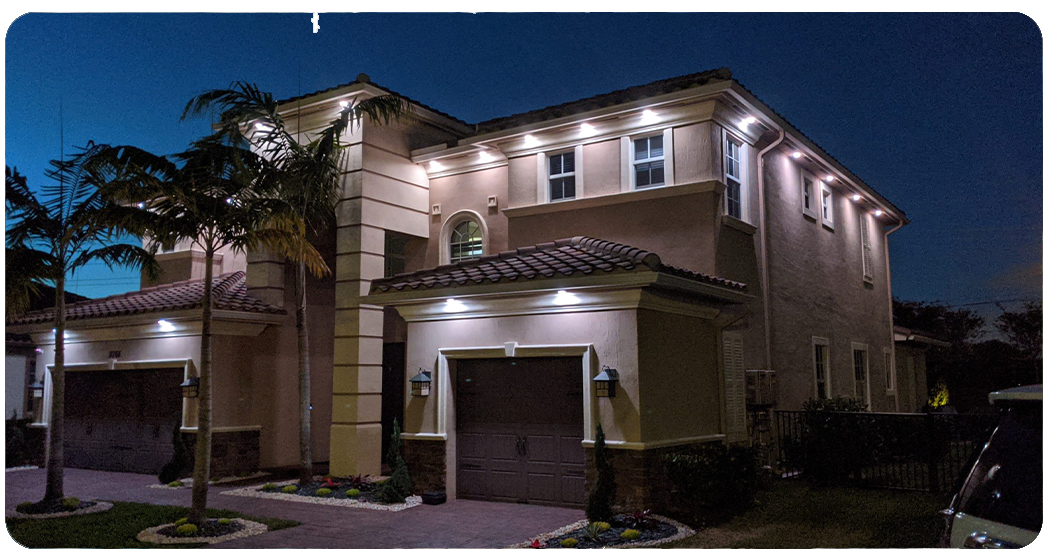 Residential exterior soffit downlighting installed on a stucco home by Anchor Electric in Sarasota Florida.