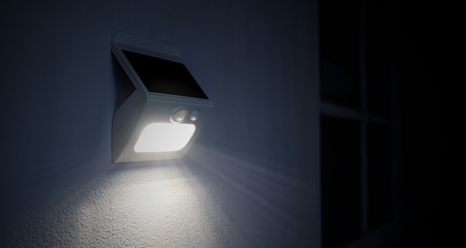 Solar powered outdoor security LED light installed on a wall by Sarasota electrical contractor