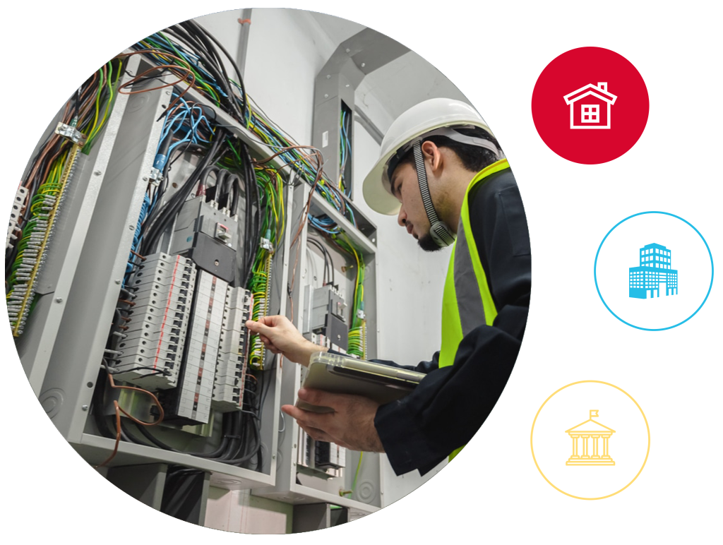 Licensed commercial electrician from Anchor Electric inspecting a complex commercial electrical panel in Sarasota, Florida.