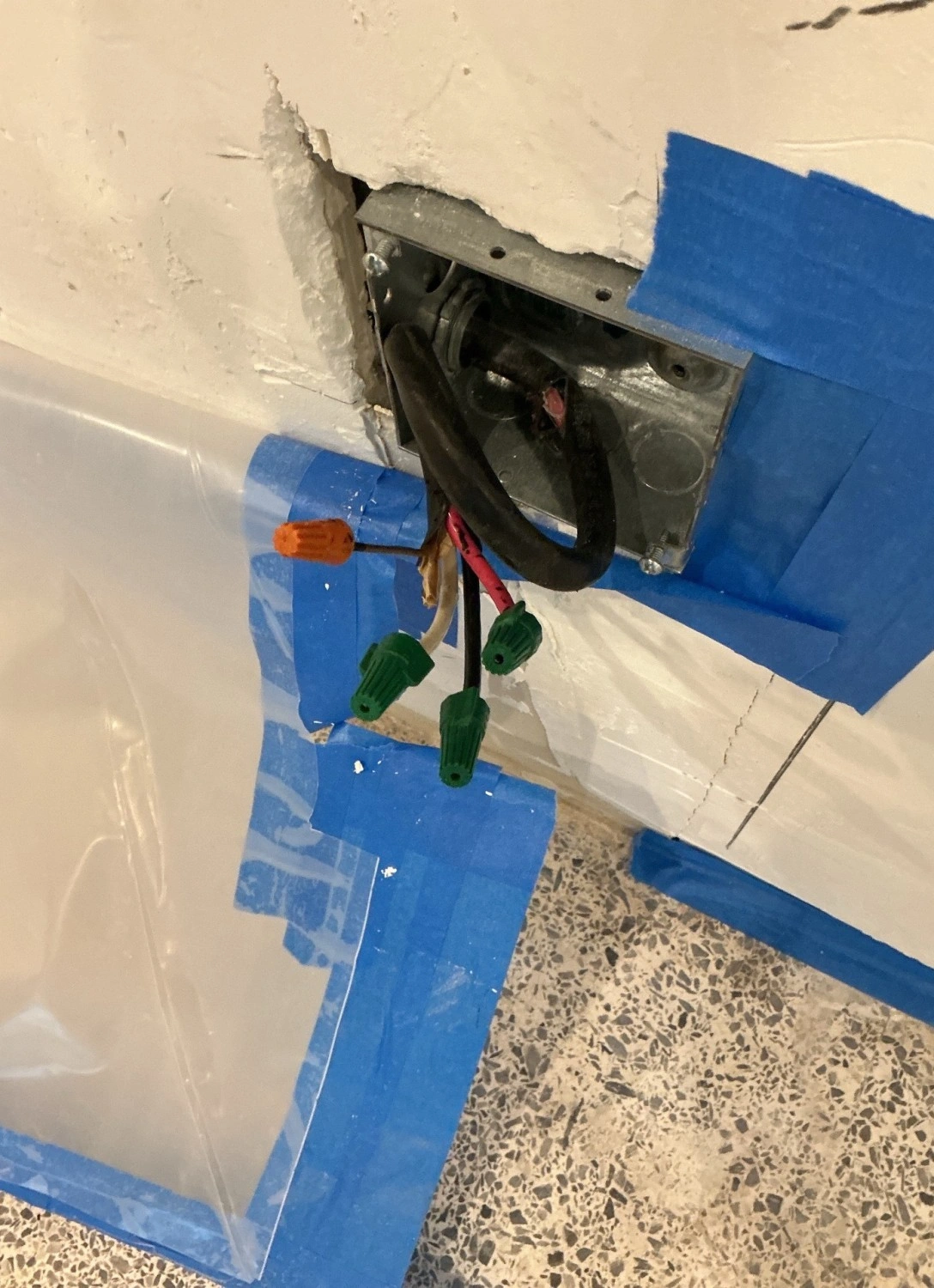 Electrician troubleshooting wiring at an electrical box
